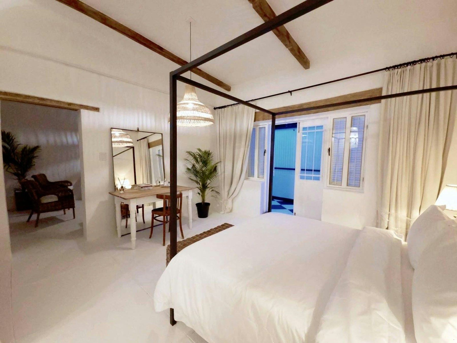 Four-poster bedroom with sheer curtains